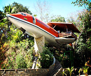 plane on a pedestal with hotel rooms