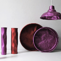 designer dinnerware, crumpled lamp shade and vasesin purple and red colors