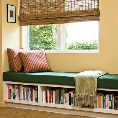 foam window seat with cushions in green and red colors, window bench with book shelves