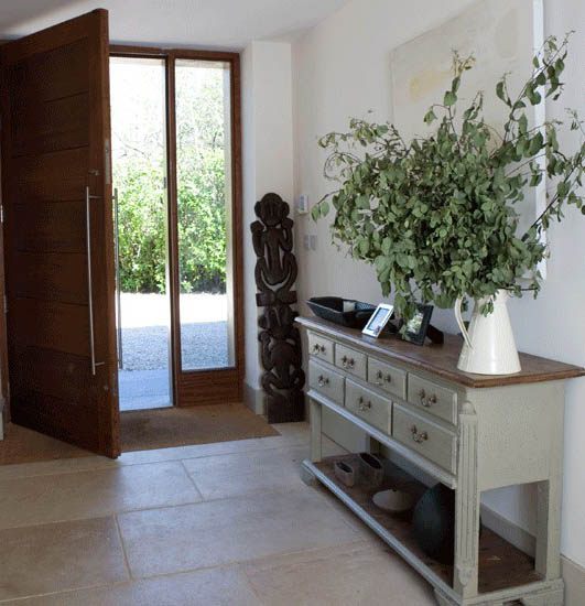 entryway decorating with light furniture and green plants