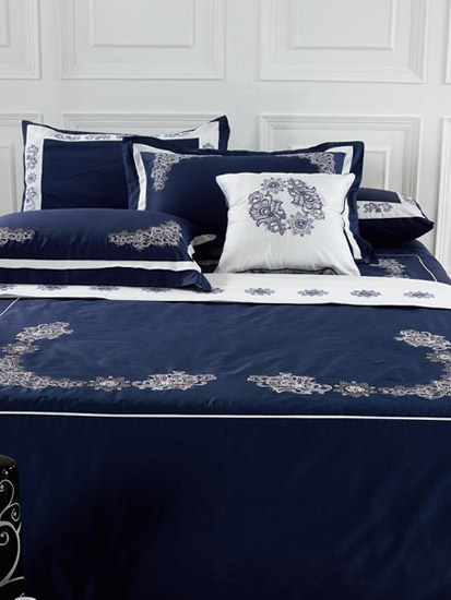 navy blue bedding set with white trim and floral designs