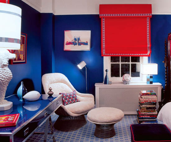 dark blue wall paint, white furniture and red shade curtain