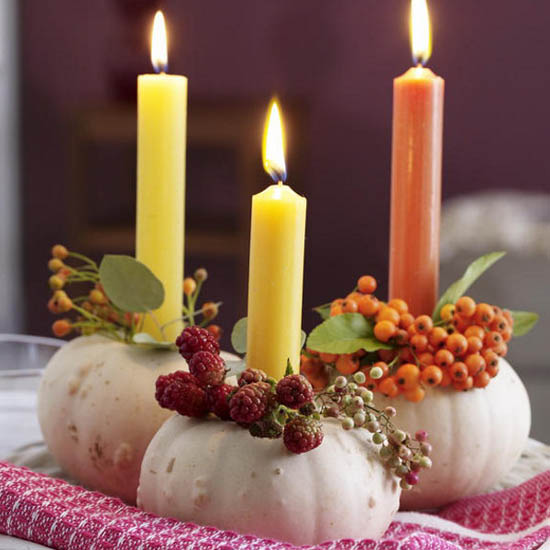 candle centerpieces made with white pumpkins, rowan berries and rose hips