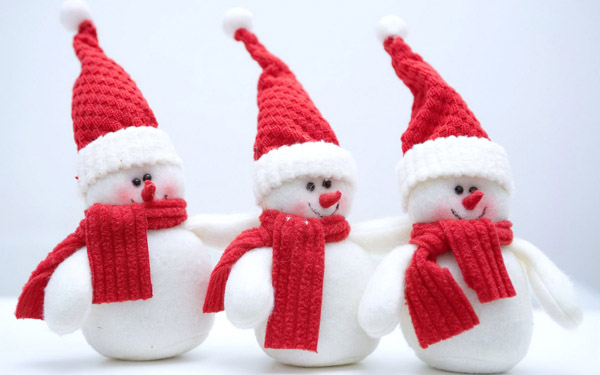 white snowmen in red hats and scarfs