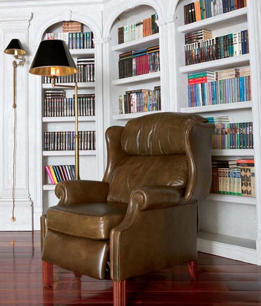 leather chair and white bookcases in home office