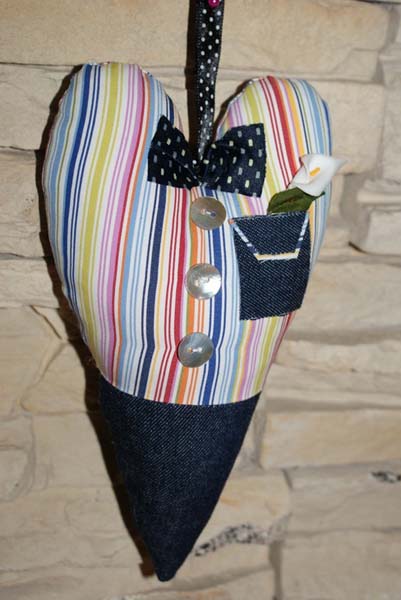 heart decoration made of striped fabric with blue bow