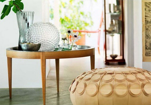 round pouf and side table with vases