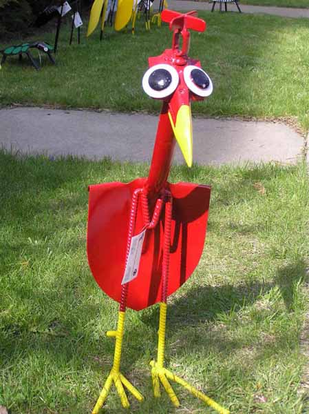 red bird made of old garden tools