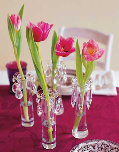 red tulips in small vases with crystals