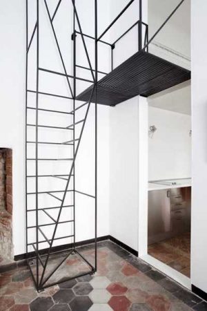 View of Unique Metal Staircase Design Allows Adding New Bedroom to Small Apartment