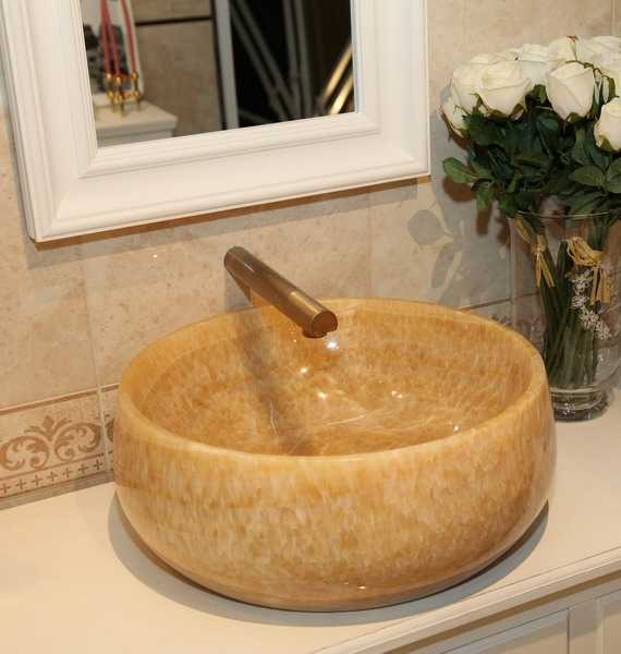 round bathroom sink made of natural stone