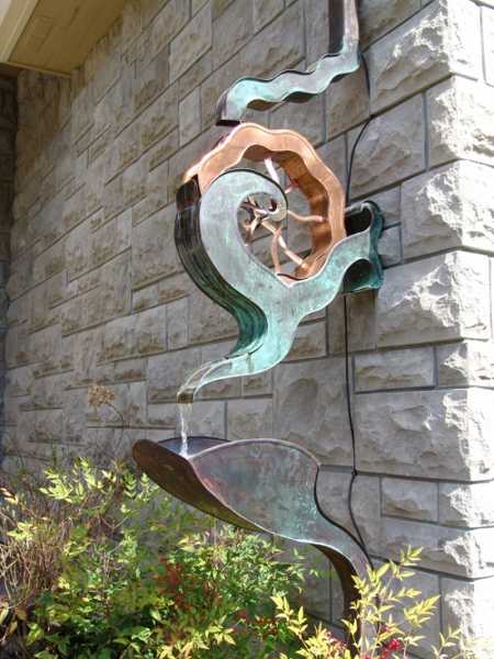 copper downspout on a stone wall