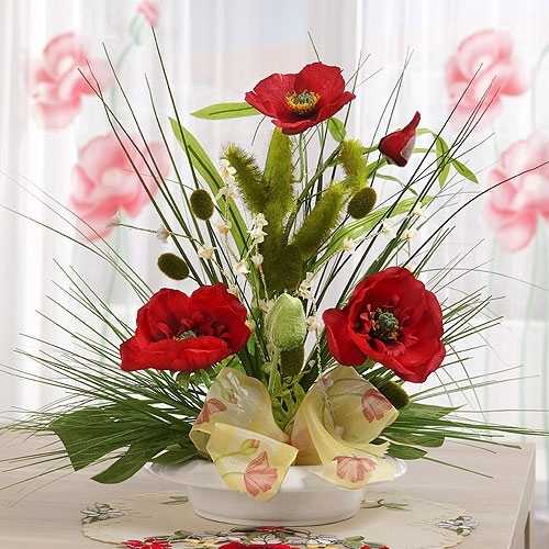 red poppy flower arrangement with green leaves