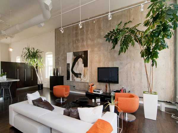 living room design with concrete wall and orange chairs