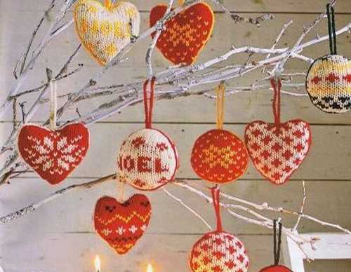 knitted christmas balls and hearts decorations in white and red colors