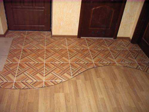 curvy joint between wooden floor and ceramic tiles