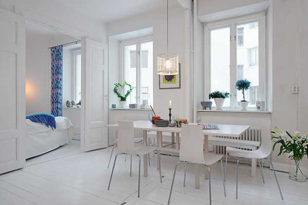 white dining furniture and indoor plants in scandinavian homes