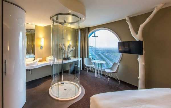 hotel room design with glass shower and large window