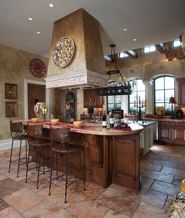 wooden kitchen island with dining shelf and stone hood