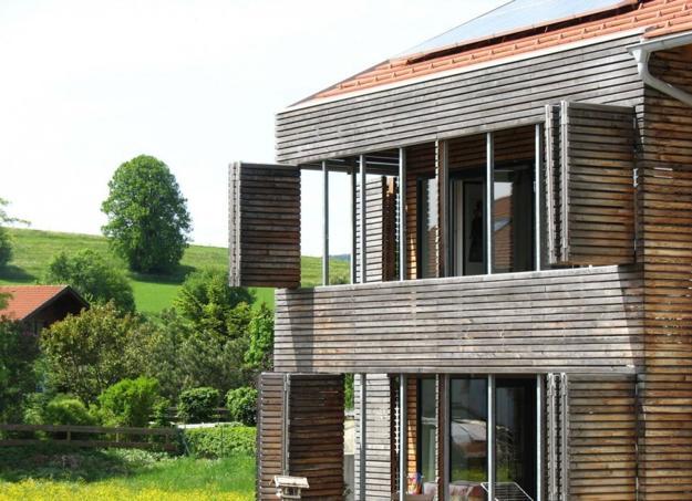 modern house exterior design with lamellas and wooden window shutters