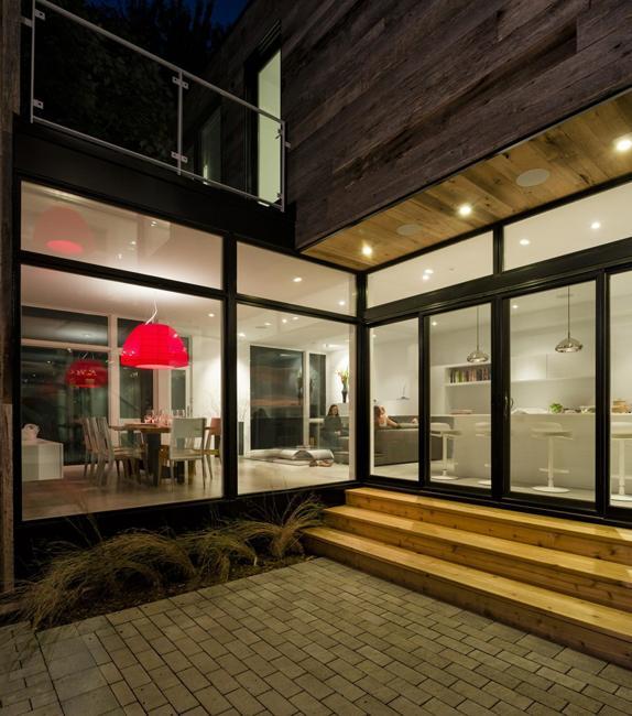 contemporary home zen barn with modern interiors in neutral colors with red lamp shades