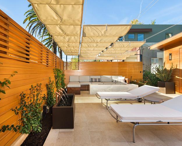 outdoor patio design with contemporary fireplace and wall fountains