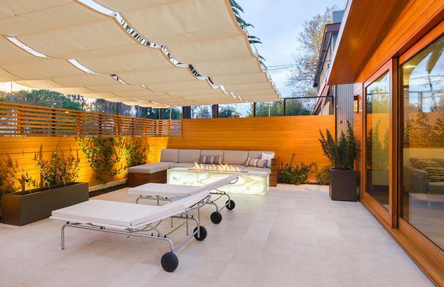 outdoor patio design with contemporary fireplace and wall fountains