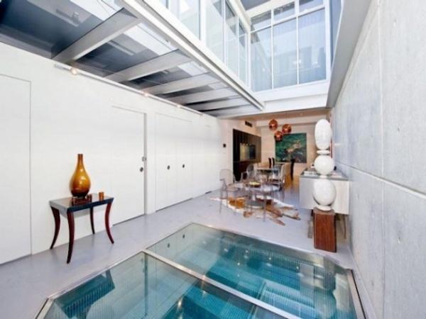small apartment with indoow swimming pool built into living room floor