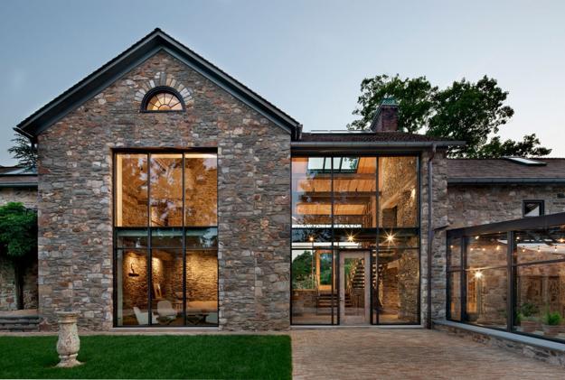 country home with antique stone walls and large windows