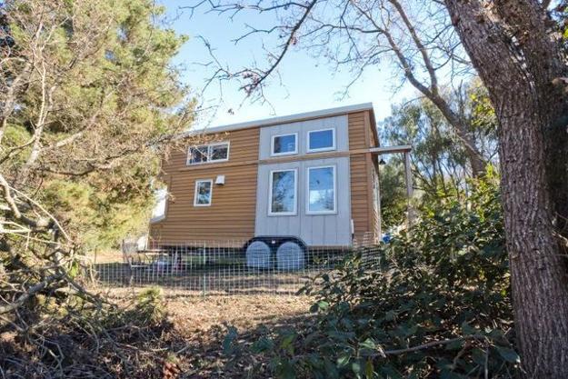 small house design with wooden interiors and wheels