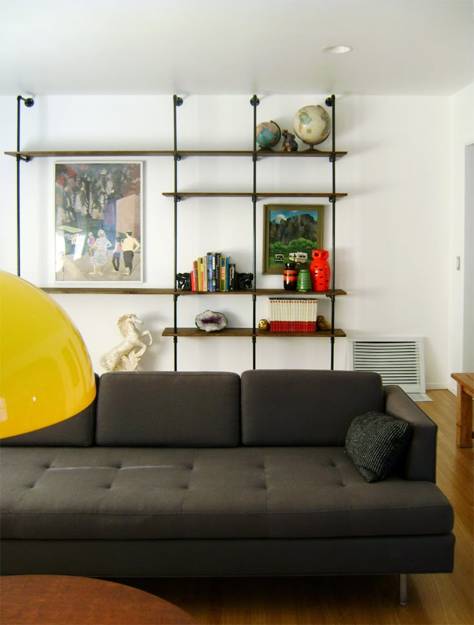 wall decoration with diy shelving unit created with pipes and wooden shelves