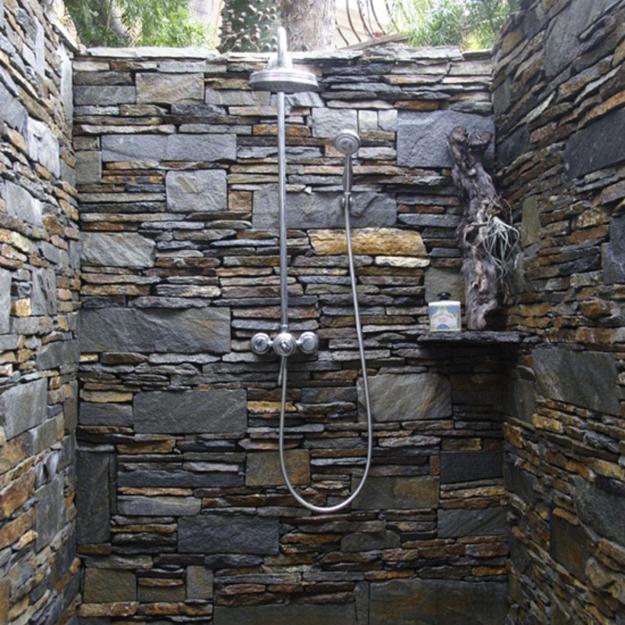 outdoor showers built with stone, concrete and tiles