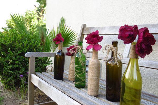 flower arrangements, table decorations and centerpieces in glass bottles