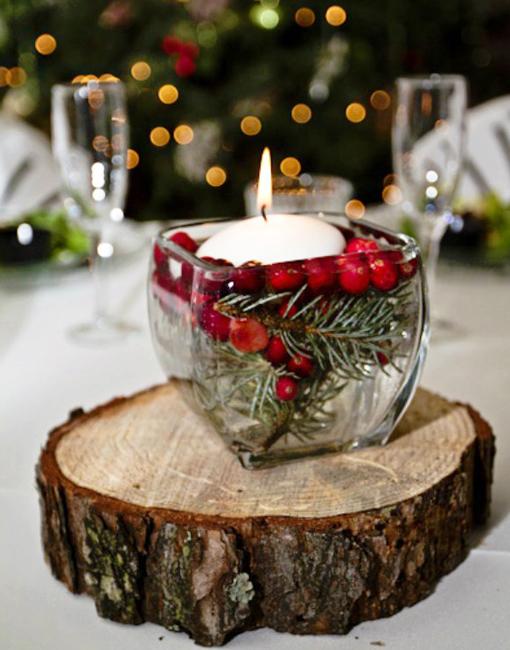 white candle and red berries table centerpiece