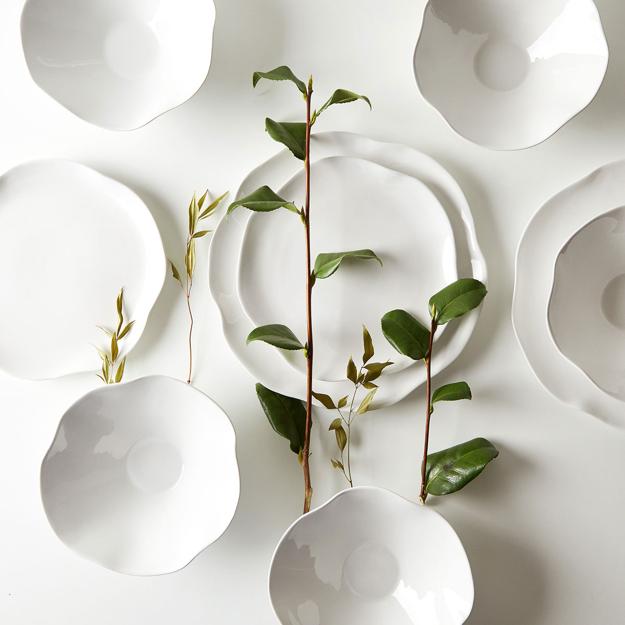 white dinnerware and green leaves for table decoration