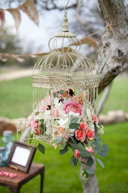 outdoor home decorating with flowers and birdcages