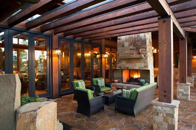 outdoor seating area with stone fireplace