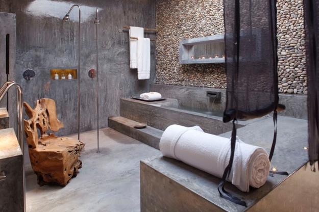 bathroom with concrete floor and stone walls