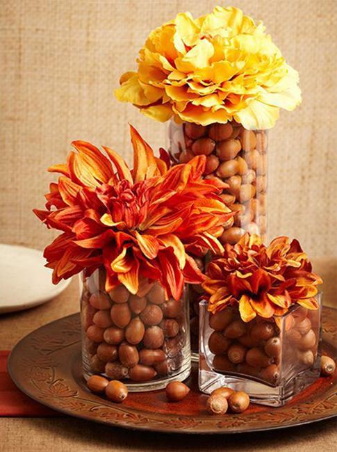 glass vase with acorns and fall flowers