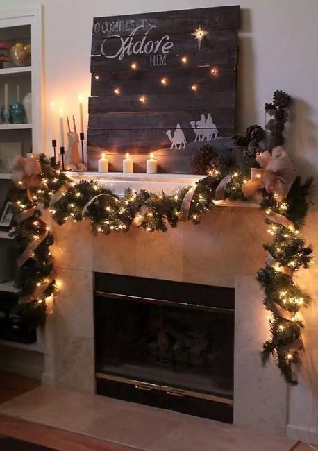 white fireplace decorated with christmas garland