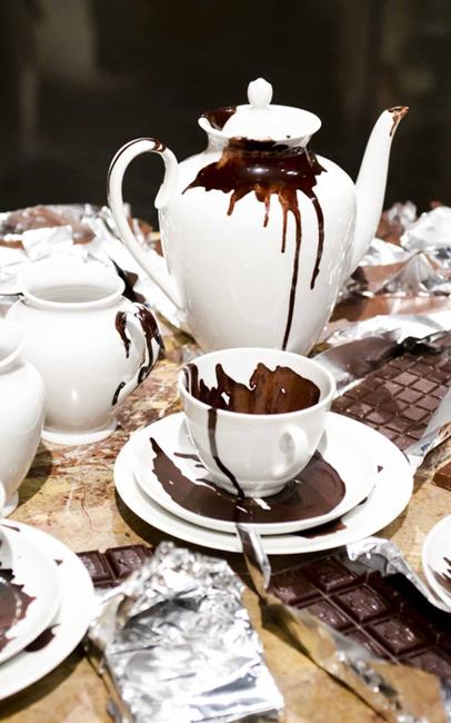 white teapot and cup chocolate spills