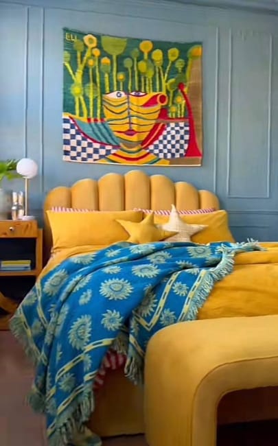 yellow upholstered bed colorful wall art