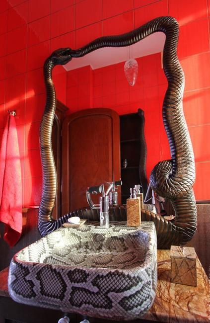 red bathroom design with snake mirror