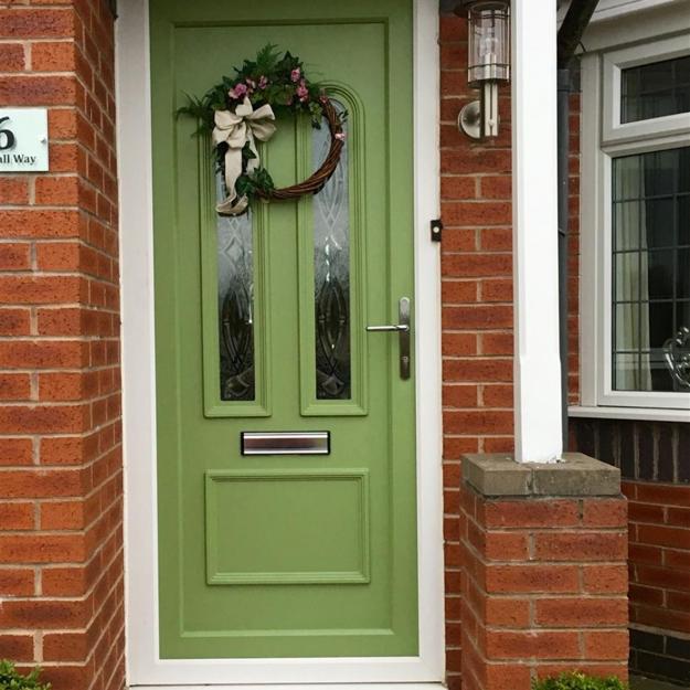 red brick walls green front door house exterior