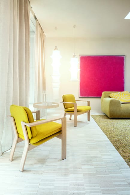 yellow chairs pink wall art