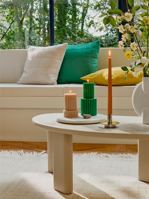 yellow green decorative pillows candles